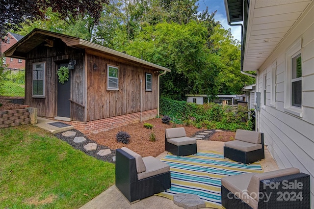 view of patio featuring an outdoor living space and an outbuilding