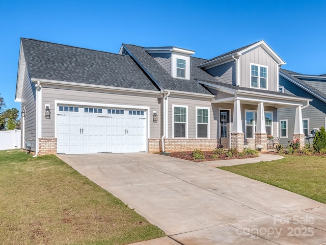 view of front of home featuring a front yard and a garage