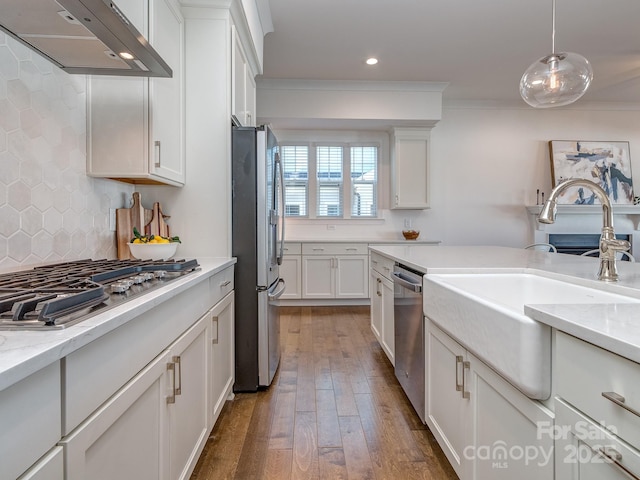 kitchen featuring backsplash, dark hardwood / wood-style floors, appliances with stainless steel finishes, decorative light fixtures, and white cabinetry