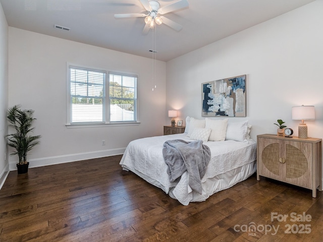 bedroom with dark hardwood / wood-style flooring and ceiling fan