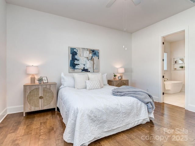 bedroom featuring ensuite bathroom, hardwood / wood-style floors, and ceiling fan