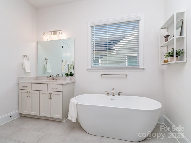 bathroom featuring tile patterned floors, a bathtub, and vanity