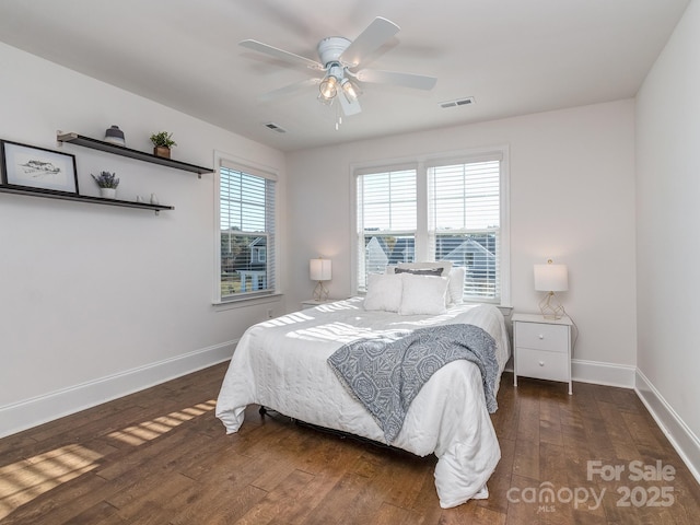 bedroom with dark hardwood / wood-style flooring and ceiling fan