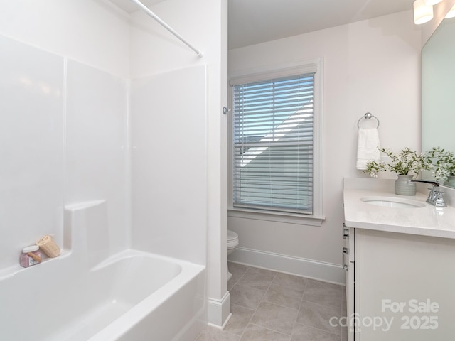 full bathroom featuring toilet, vanity, tile patterned floors, and shower / washtub combination