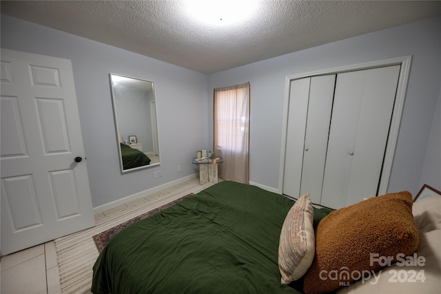 bedroom with a closet and a textured ceiling