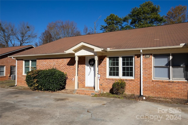 single story home featuring central air condition unit