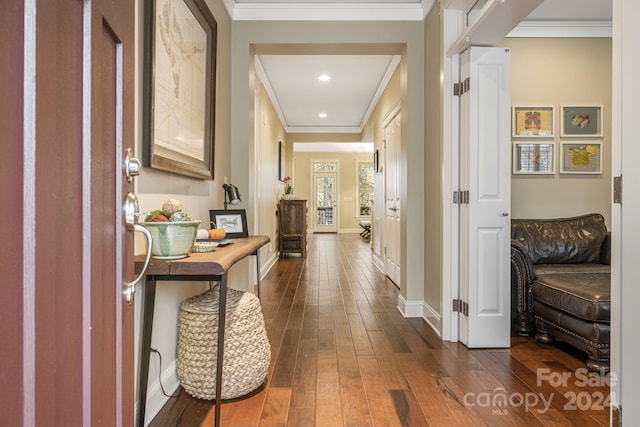 hallway with dark hardwood / wood-style flooring and ornamental molding