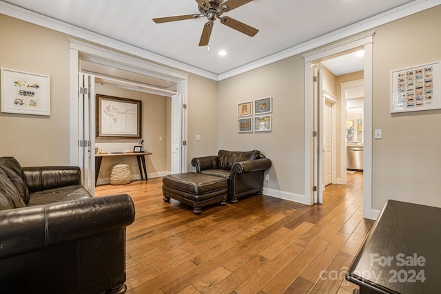 living room with ceiling fan, light hardwood / wood-style floors, and ornamental molding