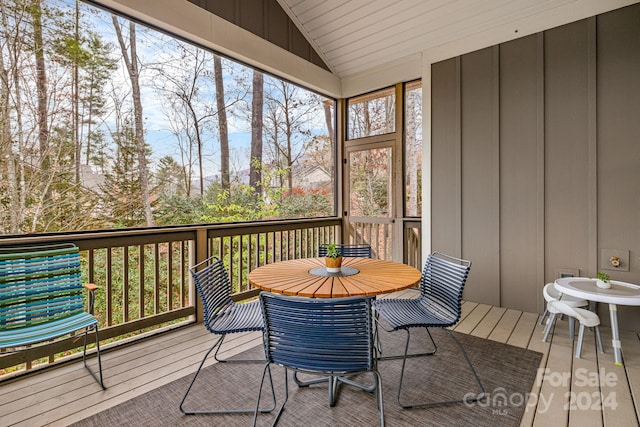 sunroom featuring lofted ceiling and a wealth of natural light