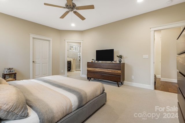 carpeted bedroom with connected bathroom and ceiling fan