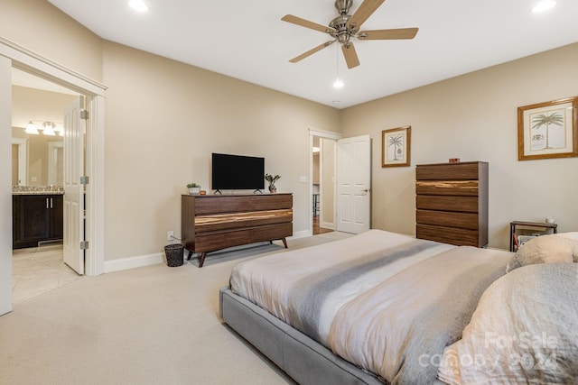 carpeted bedroom with ceiling fan and connected bathroom