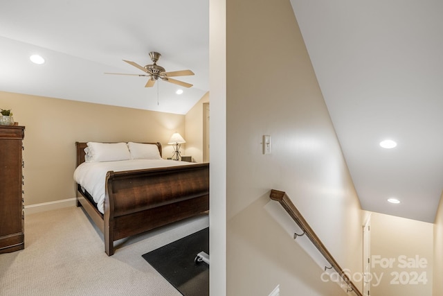 bedroom with ceiling fan, light carpet, and vaulted ceiling