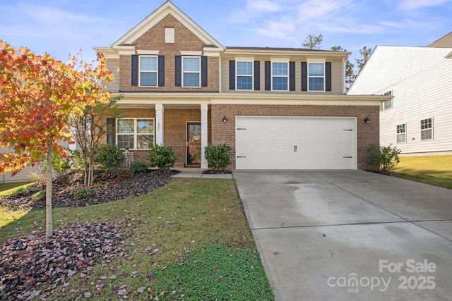 view of front of house with a garage, a front yard, and covered porch