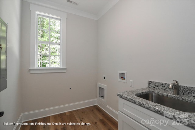 clothes washing area with a sink, electric dryer hookup, cabinet space, dark wood-style floors, and washer hookup