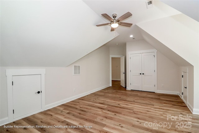 bonus room with light wood finished floors, vaulted ceiling, visible vents, and a ceiling fan