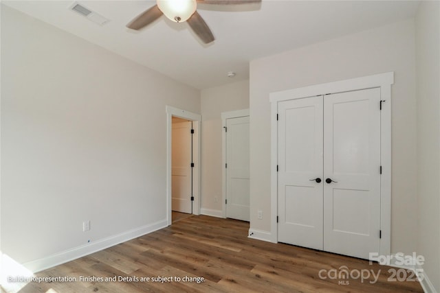 unfurnished bedroom featuring wood finished floors, visible vents, baseboards, and ceiling fan