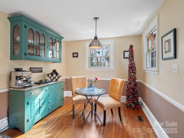 dining room with breakfast area and light hardwood / wood-style flooring