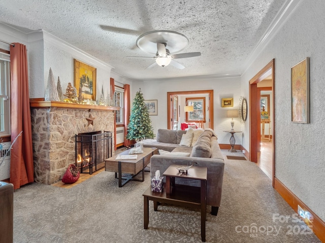 living room featuring crown molding, ceiling fan, carpet flooring, a textured ceiling, and a stone fireplace