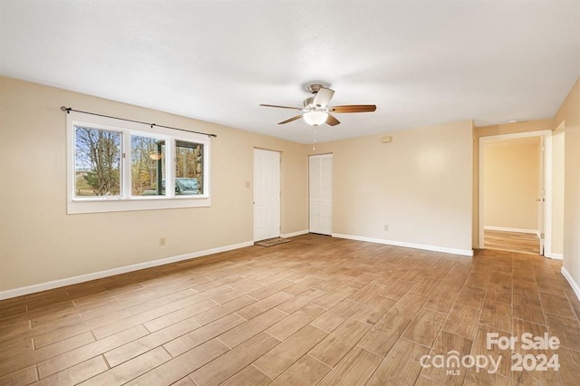 unfurnished room featuring ceiling fan and light wood-type flooring