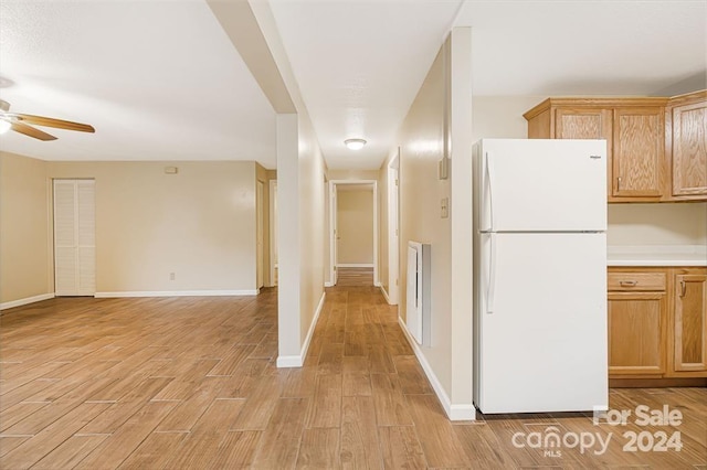 kitchen with white refrigerator, light hardwood / wood-style floors, and ceiling fan