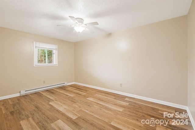 unfurnished room with hardwood / wood-style floors, a textured ceiling, a baseboard radiator, and ceiling fan