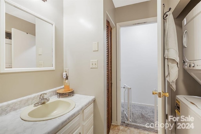 bathroom featuring vanity and stacked washer / drying machine