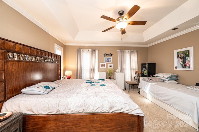 bedroom featuring carpet, a raised ceiling, ceiling fan, and crown molding