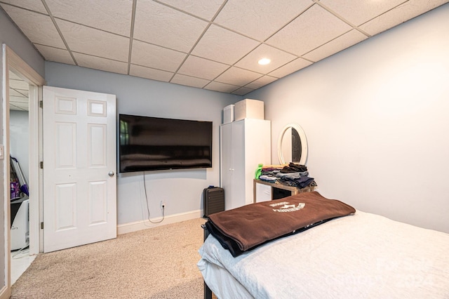 carpeted bedroom with a drop ceiling