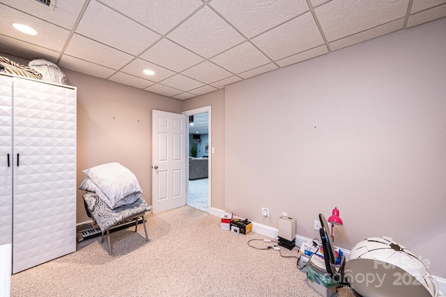 playroom with a paneled ceiling and carpet