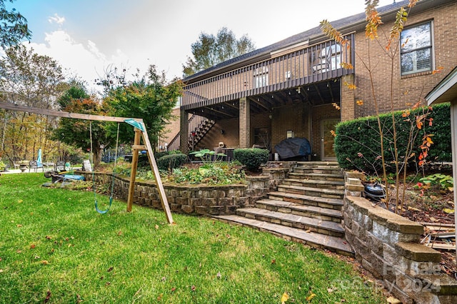 view of yard featuring a playground and a deck