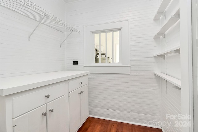 walk in closet with dark wood-type flooring