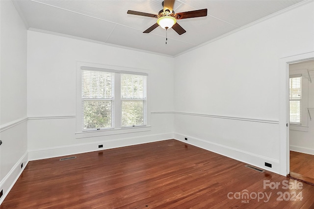 spare room featuring hardwood / wood-style floors, ceiling fan, a healthy amount of sunlight, and crown molding