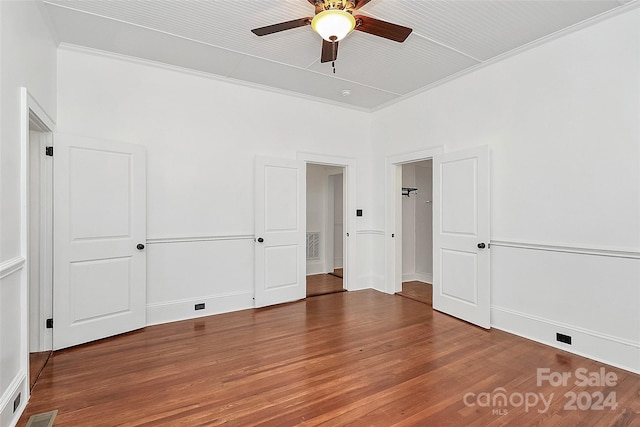 unfurnished bedroom with ceiling fan, crown molding, and hardwood / wood-style flooring