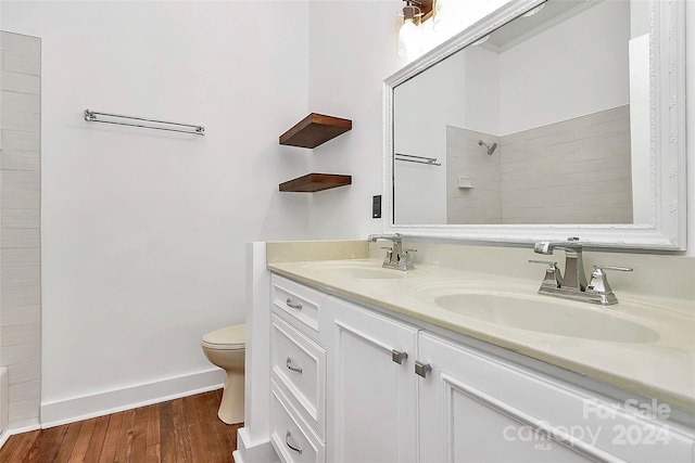 bathroom with vanity, toilet, wood-type flooring, and walk in shower