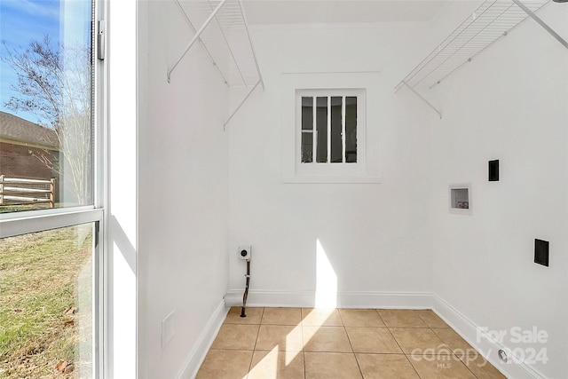 clothes washing area with hookup for a washing machine, light tile patterned floors, and electric dryer hookup