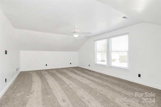 additional living space with carpet flooring, ceiling fan, and lofted ceiling