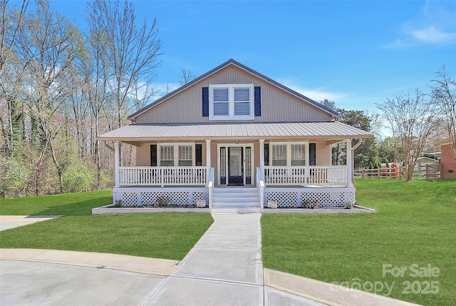 view of front of home with metal roof, a front yard, and a porch