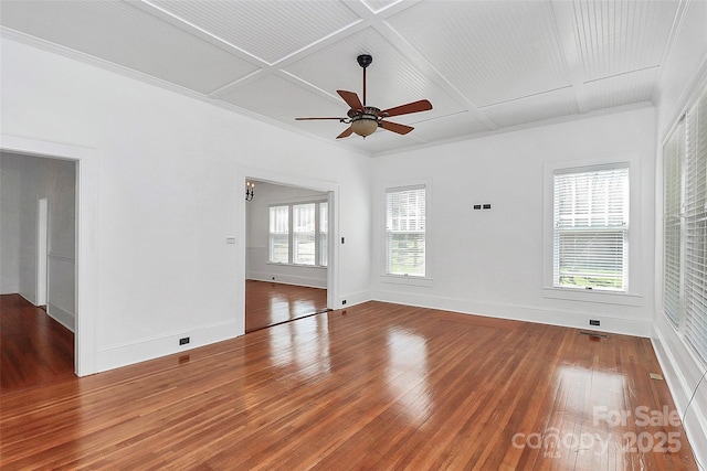 spare room featuring coffered ceiling, crown molding, hardwood / wood-style flooring, baseboards, and ceiling fan