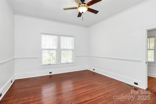 unfurnished room with wood-type flooring, a ceiling fan, crown molding, and visible vents