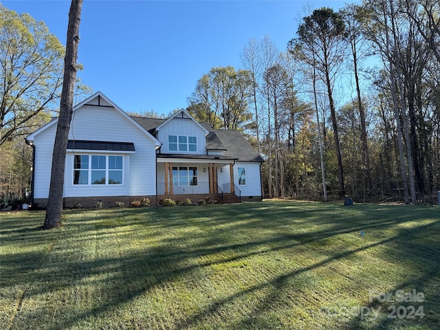 view of front of house with covered porch and a front yard