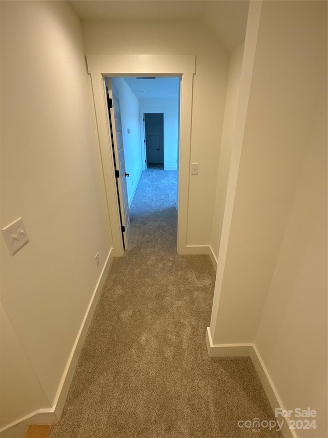 hallway with light colored carpet