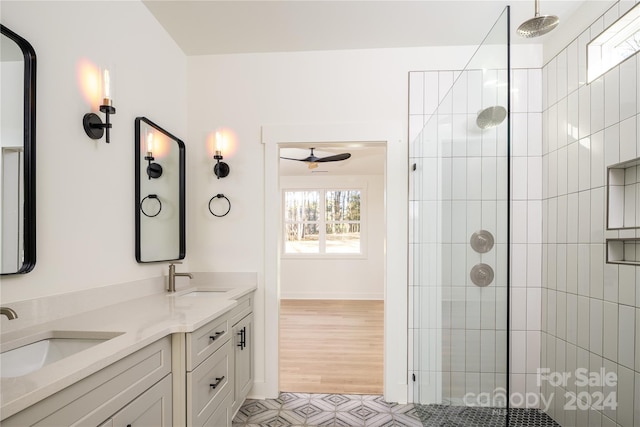 bathroom with wood-type flooring, vanity, a shower with door, and ceiling fan