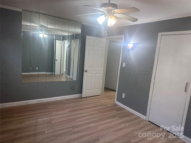 unfurnished bedroom with crown molding, light hardwood / wood-style flooring, and ceiling fan