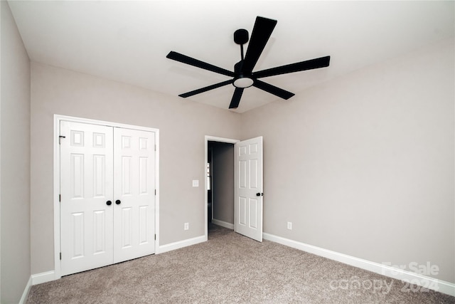 unfurnished bedroom with ceiling fan, a closet, and light carpet