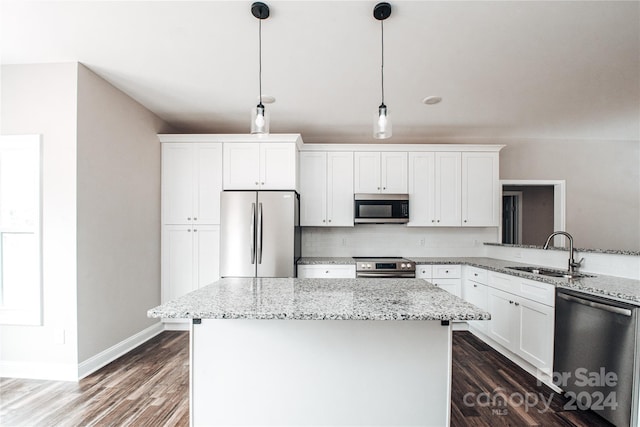 kitchen with dark hardwood / wood-style floors, white cabinetry, sink, and appliances with stainless steel finishes