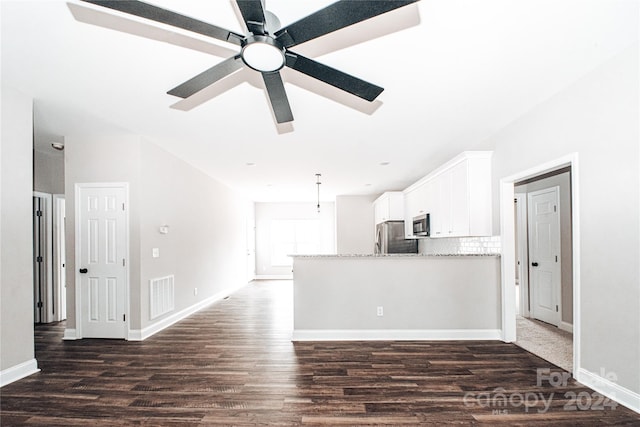 unfurnished living room featuring ceiling fan and dark hardwood / wood-style flooring