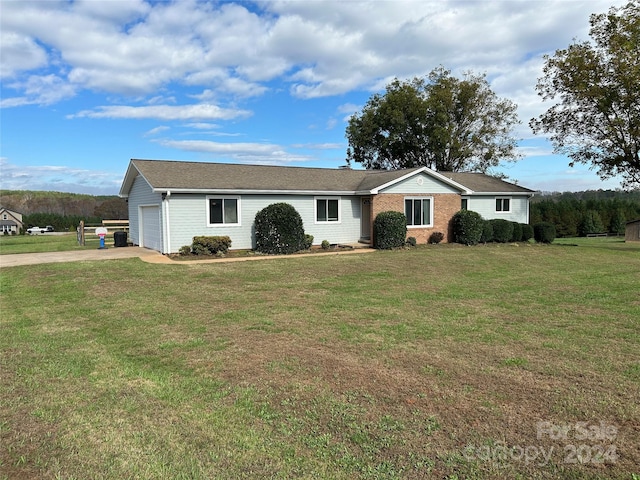 single story home with a front yard and a garage