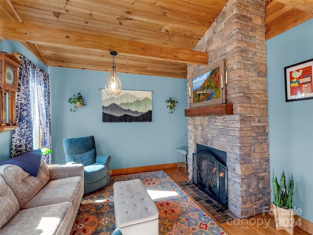 living room with vaulted ceiling, a stone fireplace, wood ceiling, and dark hardwood / wood-style floors