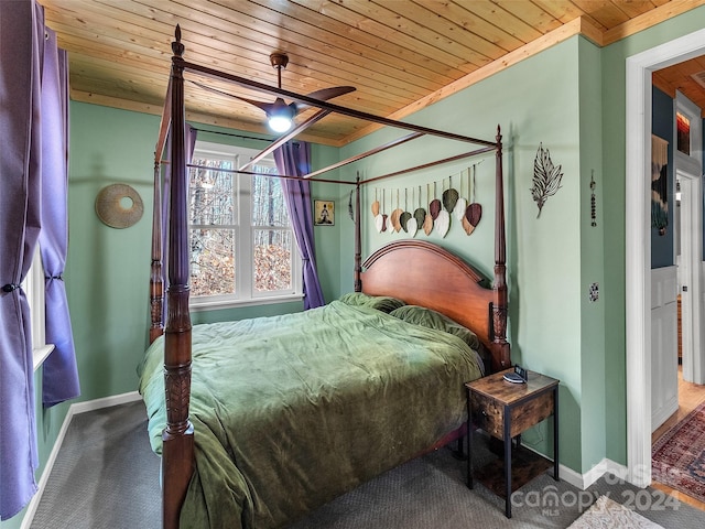 carpeted bedroom featuring ornamental molding, ceiling fan, and wooden ceiling