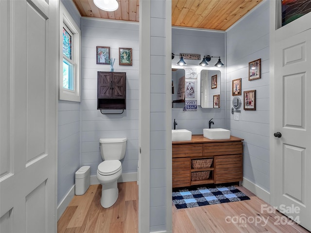 bathroom featuring hardwood / wood-style floors, vanity, and wood ceiling